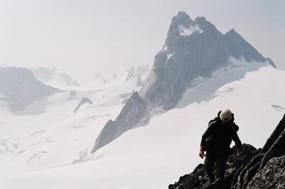 Climber approaching a Bugaboo spire in misty conditions