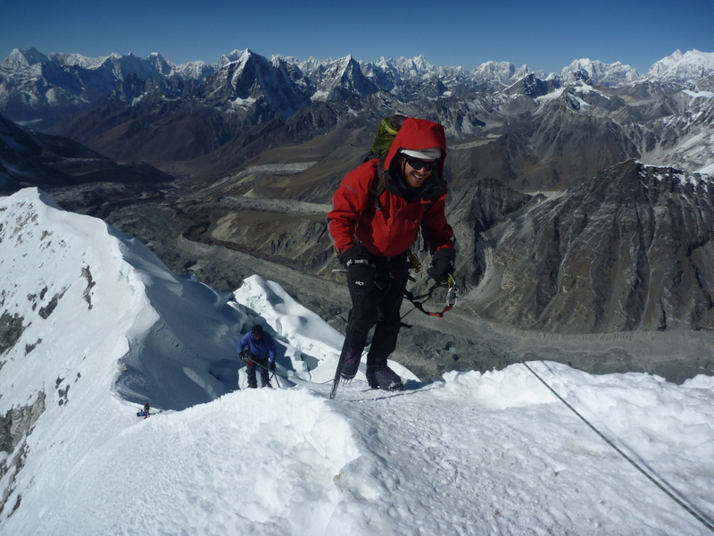 Jon on the summit ridge of Island Peak, Nepal, with the Himalayan range behind