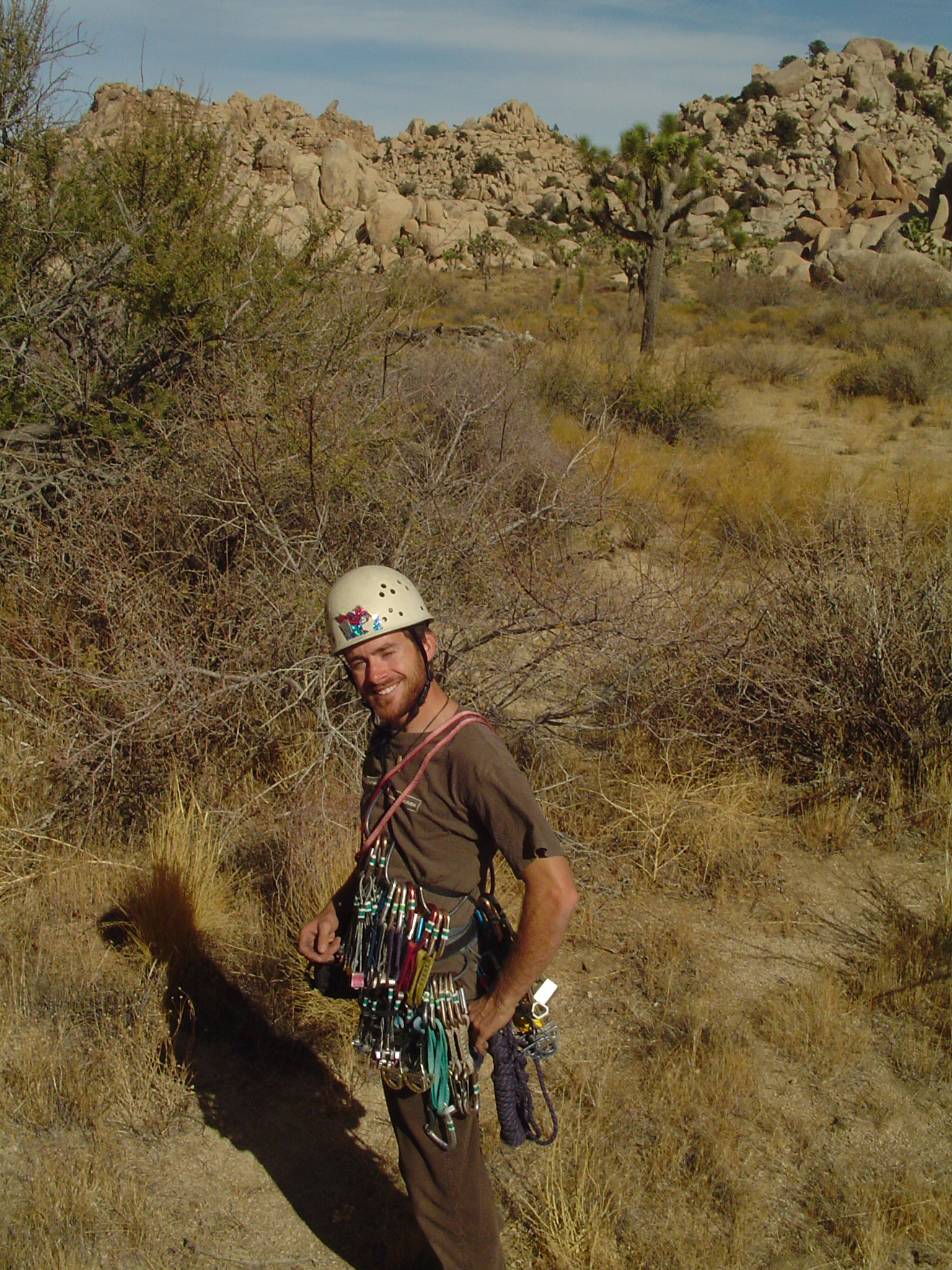 Jon at Joshua Tree, fully racked with gear, smiling